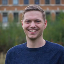 Young man (Alexander Lichter) wearing a suite, nature in the background